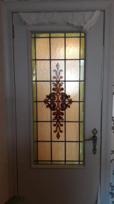 Rechthoekig glasraam in deur met plantmotief